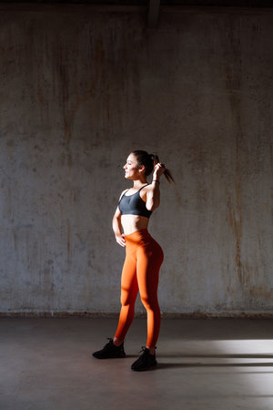 Young female athlete training in a gym using sport equipment. Fit woman working out. Concept about fitness, wellness and sport preparation.の写真素材