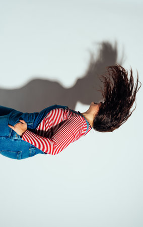 Plus size woman model posing in studio and having fun. Shots taken on white background and direct hard lightの写真素材
