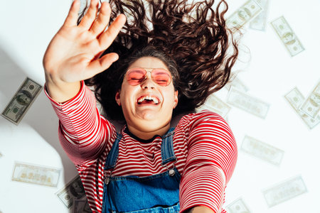 Plus size woman model posing in studio and having fun. Shots taken on white background and direct hard lightの写真素材