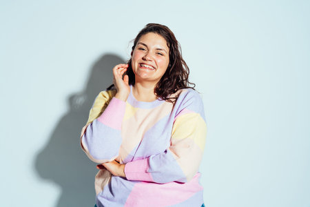 Plus size woman model posing in studio and having fun. Shots taken on white background and direct...