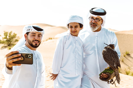 Three generation family making a safari in the desert of Dubai. Grandfather, son and grandson...