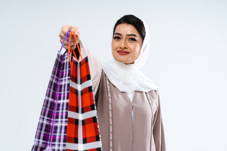 Beautiful arab middle-eastern woman with traditional abaya dress in studio - Arabic muslim adult female portrait in Dubai, United Arab Emiratesの写真素材