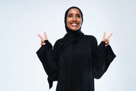 Beautiful arab middle-eastern woman with traditional abaya dress in studio - Arabic muslim adult female portrait in Dubai, United Arab Emiratesの写真素材