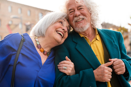 Senior couple of old people dating outdoors - Married elderly man and woman in love spending time together - Grandparents having fun strolling in the cityの写真素材