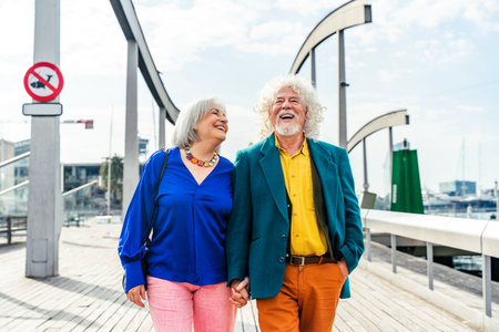 Senior couple of old people dating outdoors - Married elderly man and woman in love spending time together - Grandparents having fun strolling in the cityの写真素材