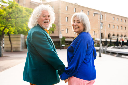 Senior couple of old people dating outdoors - Married elderly man and woman in love spending time together - Grandparents having fun strolling in the cityの写真素材