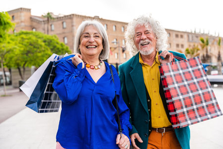 Senior couple of old people dating outdoors - Married elderly man and woman in love spending time together - Grandparents having fun strolling in the cityの写真素材