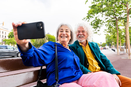 Senior couple of old people dating outdoors - Married elderly man and woman in love spending time together - Grandparents having fun strolling in the cityの写真素材