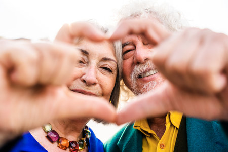 Senior couple of old people dating outdoors - Married elderly man and woman in love spending time...