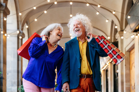 Senior couple of old people dating outdoors - Married elderly man and woman in love spending time together - Grandparents having fun strolling in the cityの写真素材