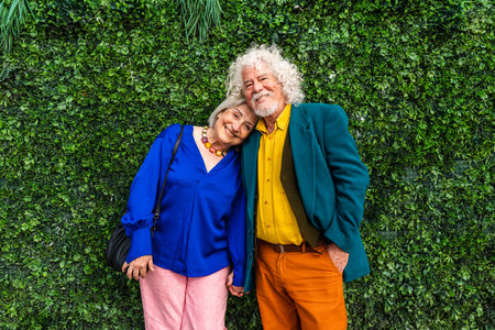 Senior couple of old people dating outdoors - Married elderly man and woman in love spending time together - Grandparents having fun strolling in the cityの写真素材