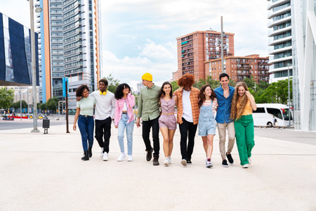 Happy playful multiethnic group of young friends bonding outdoors - Multiracial millennials students meeting in the city, concepts of youth, people lifestyle, diversity, teenage and urban lifeの写真素材