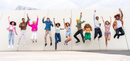 Happy playful multiethnic group of young friends bonding outdoors - Multiracial millennials students...