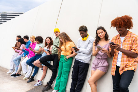 Happy playful multiethnic group of young friends bonding outdoors - Multiracial millennials students...