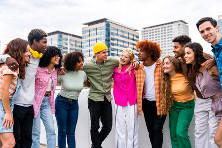 Happy playful multiethnic group of young friends bonding outdoors - Multiracial millennials students meeting in the city, concepts of youth, people lifestyle, diversity, teenage and urban lifeの写真素材