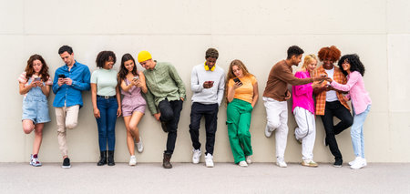 Happy playful multiethnic group of young friends bonding outdoors - Multiracial millennials students meeting in the city, concepts of youth, people lifestyle, diversity, teenage and urban lifeの写真素材