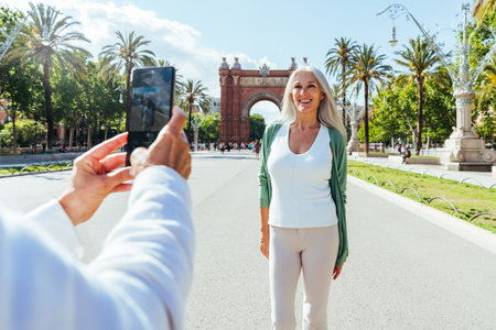 Beautiful senior women bonding outdoors in the city - Attractive cheerful mature female friends having fun, shopping and bonding, concepts about elderly lifestyleの写真素材