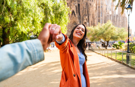 Multiracial beautiful happy couple of lovers dating at Sagrada Familia, Barcelona - Multiethnic tourists traveling in Europe and visiting a city in Spain, concepts about tourism and people lifestyleの写真素材