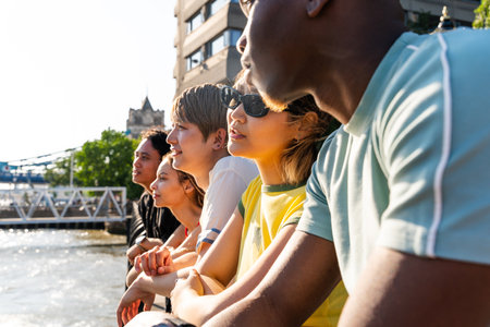 Multiracial group of happy young friends bonding in London city - Multiethnic teens students meeting and having fun in Tower Bridge area, UK - Concepts about youth lifestyle, travel and tourismの写真素材