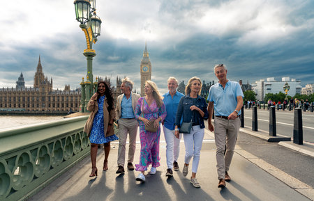 Group of old friends spending time together in the main parts of London, visiting the Westminster area and St. james park. Old buddies reunion. Concept about third age and seniorityの写真素材