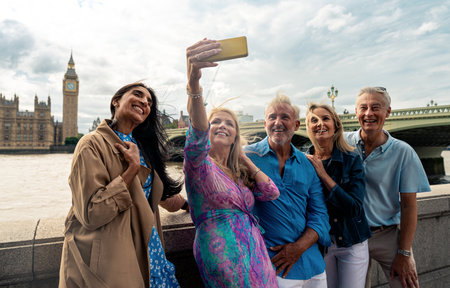 Group of old friends spending time together in the main parts of London, visiting the Westminster area and St. james park. Old buddies reunion. Concept about third age and seniorityの写真素材