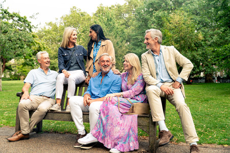 Group of old friends spending time together in the main parts of London, visiting the Westminster area and St. james park. Old buddies reunion. Concept about third age and seniorityの写真素材