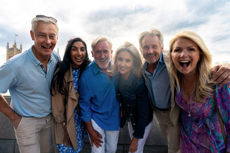 Group of old friends spending time together in the main parts of London, visiting the Westminster area and St. james park. Old buddies reunion. Concept about third age and seniorityの写真素材