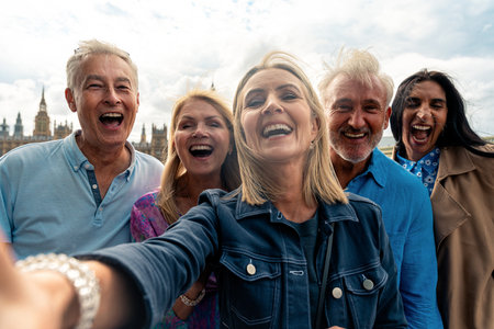 Group of old friends spending time together in the main parts of London, visiting the Westminster area and St. james park. Old buddies reunion. Concept about third age and seniorityの写真素材