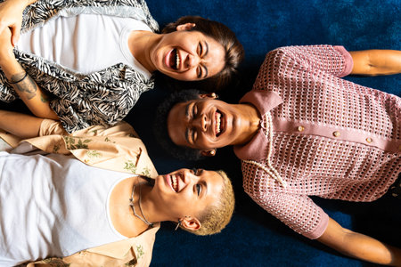 Group of friends bonding at home, LGBTQ and diversity concepts - Homosexual couple and fluid gender non binary young man with cross dressing clothing style having fun in the apartment, LGBT people conceptsの写真素材