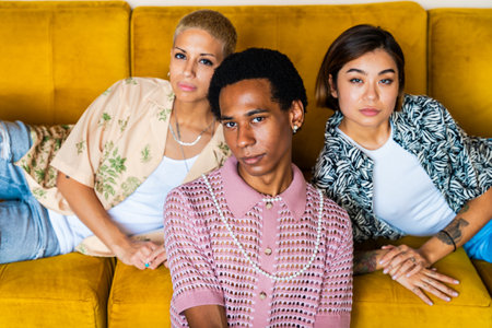 Group of friends bonding at home, LGBTQ and diversity concepts - Homosexual couple and fluid gender non binary young man with cross dressing clothing style having fun in the apartment, LGBT people conceptsの写真素材