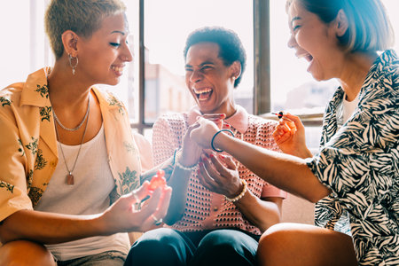 Group of friends bonding at home, LGBTQ and diversity concepts - Homosexual couple and fluid gender non binary young man with cross dressing clothing style having fun in the apartment, LGBT people conceptsの写真素材