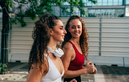 LGBT couple training together outdoor. Runner real couple doing sport in an urban area of the city. Concepts of sports and lifestyleの写真素材