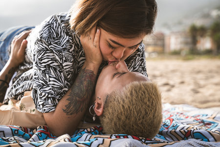 Beautiful multiethnic lesbian couple of lovers dating outdoors - LGBT people bonding and spending time together, concepts about LGBTQ community, diversity, love and lifestyleの写真素材