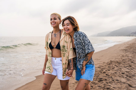 Beautiful multiethnic lesbian couple of lovers dating outdoors - LGBT people bonding and spending...