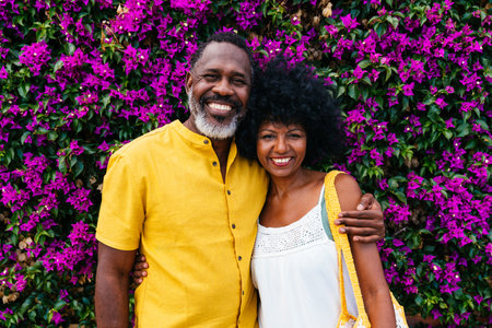 Beautiful mature black couple of lovers dating at the seaside - Married african middle-aged couple bonding and having fun outdoors, concepts about relationship, lifestyle and quality of lifeの写真素材