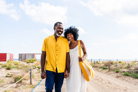 Beautiful mature black couple of lovers dating at the seaside - Married african middle-aged couple...