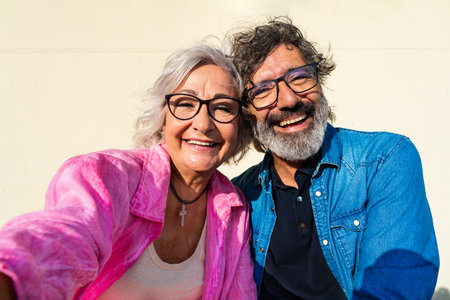 Beautiful happy senior couple bonding outdoors - Cheerful old people romantic dating in the city,...