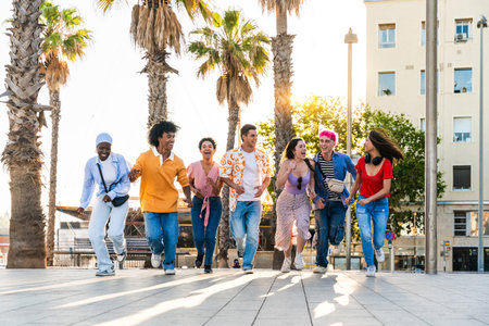 Multiethnic group of young happy friends hanging out in the city - Multiracial group of students meeting and having fun outdoors, concepts about youth, teenage, diversity and lifestyleの写真素材