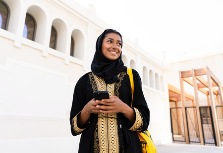 Traditional arab woman wearing abaya outdoors - Beautiful middle-eastern adult female portrait in...