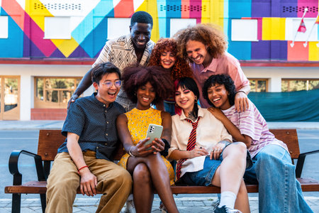 Multiethnic group of young friends meeting and having fun outdoors - Multiracial happy and stylish teen students bonding in the city, concepts about youth, teenagers lifestyle and diversityの写真素材