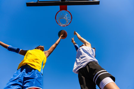 Multiethnic female basketball players training at city basketball court - Athletic women playing...