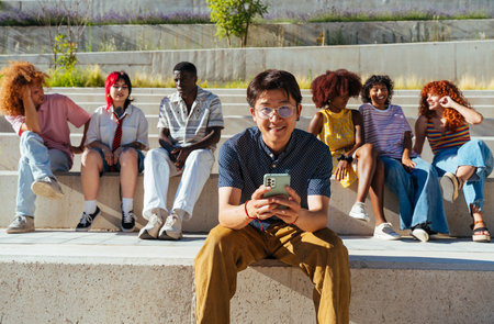 Multiethnic group of young friends meeting and having fun outdoors - Multiracial happy and stylish teen students bonding in the city, concepts about youth, teenagers lifestyle and diversityの写真素材