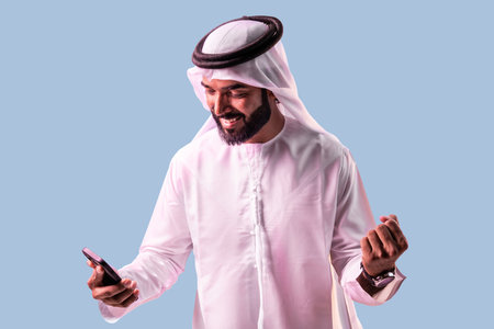 Arab businessman wearing emirates kandura portrait in studio in Dubai - Handsome middle eastern male...