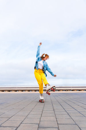 Beautiful red haired young woman with rollerskates having fun outdoors - Pretty female teenager girl...