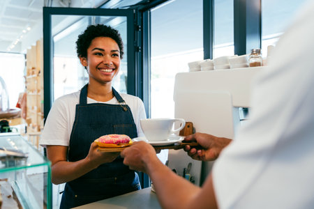 Bakery, happy portrait of hispanic black man and woman in cafe ready for serving pastry, coffee and baked foods - Confident waiter barista by counter for service, help and welcome in a coffee shopの写真素材