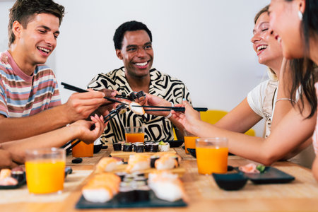 Multiethnic group of young friends meeting at home and eating sushi - Multiracial happy people...