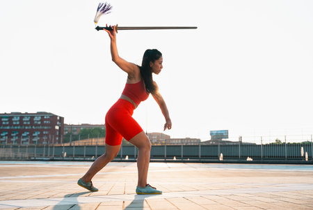 Chinese young woman practicing wushu kung fu with weapons outdoor. Young girl training martial arts form for the competition.の写真素材