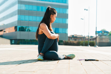 Young woman practicing martial arts with weapons outdoor. Young girl training martial arts form for...