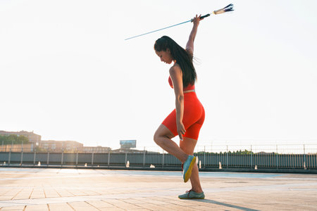 Chinese young woman practicing wushu kung fu with weapons outdoor. Young girl training martial arts form for the competition.の写真素材