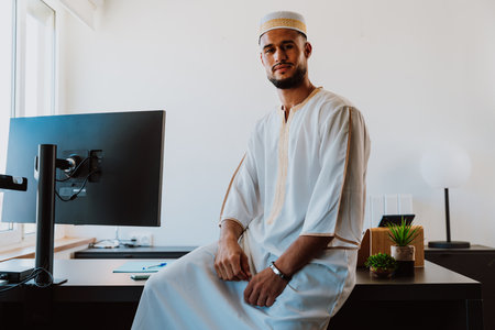 Moroccan Business man in the office. Young business man with traditional outfit working in his office.の写真素材